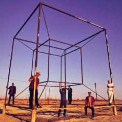 The Slackers performing outdoors beneath large geometric metal structure during 2026 tour stop promoting live show at The Hive in Flagstaff Arizona